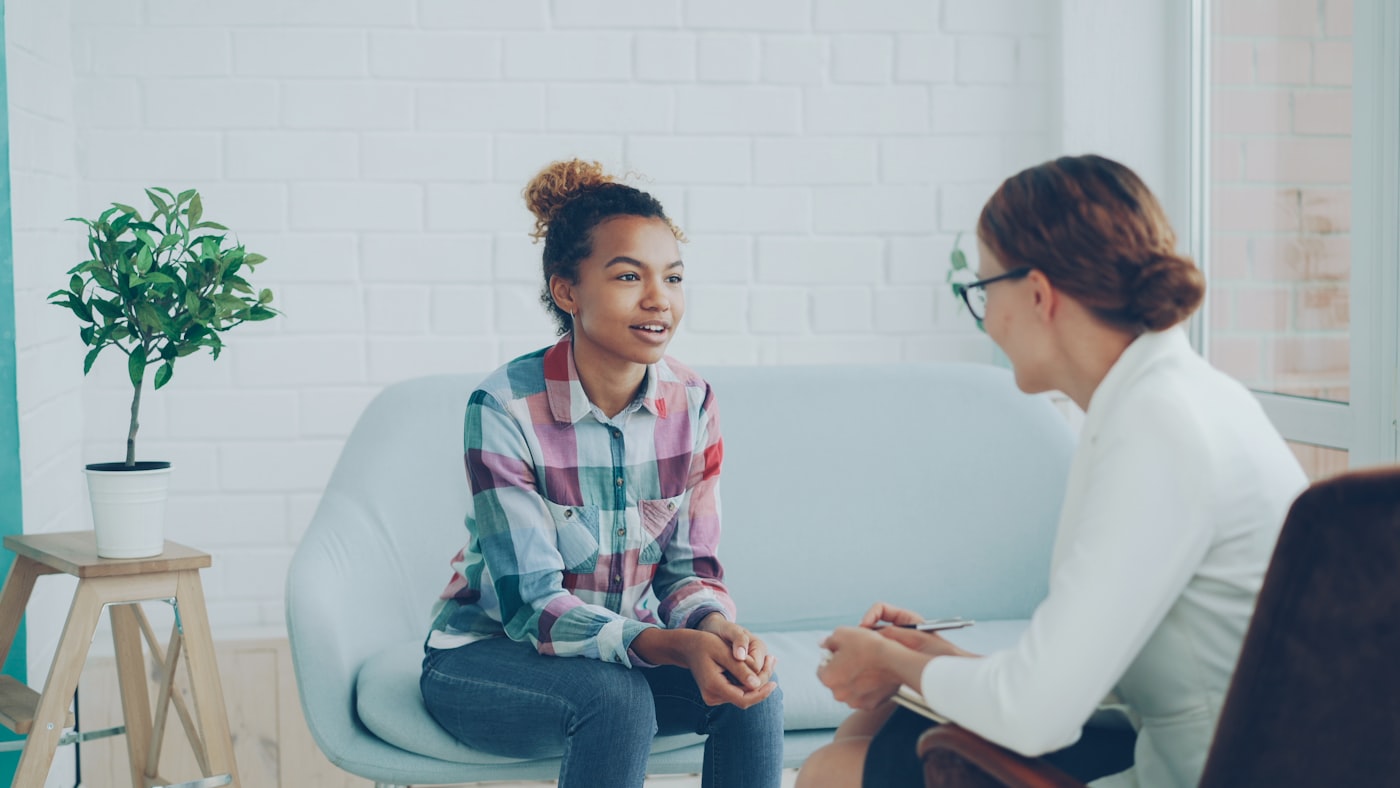Supportive counselor talking with a client during an addiction treatment session