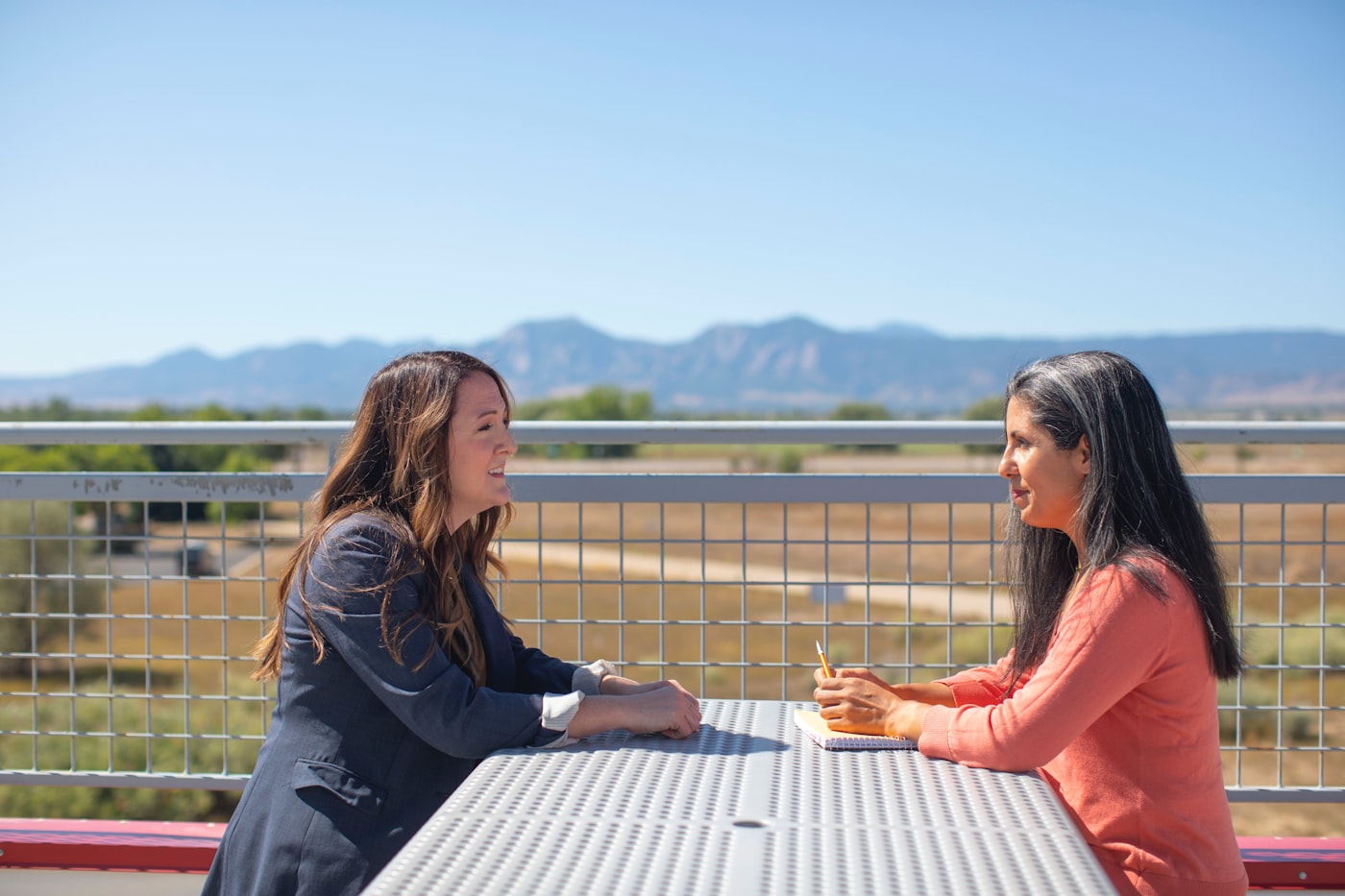 Two women talking supportively during an aftercare conversation