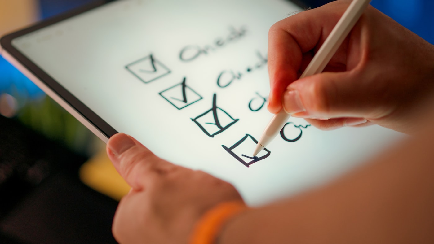 Self-assessment checklist and pen for reflecting on alcohol use