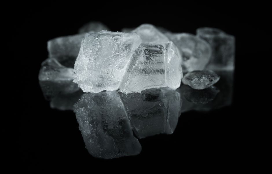 Crystalline methamphetamine powder residue on a reflective surface