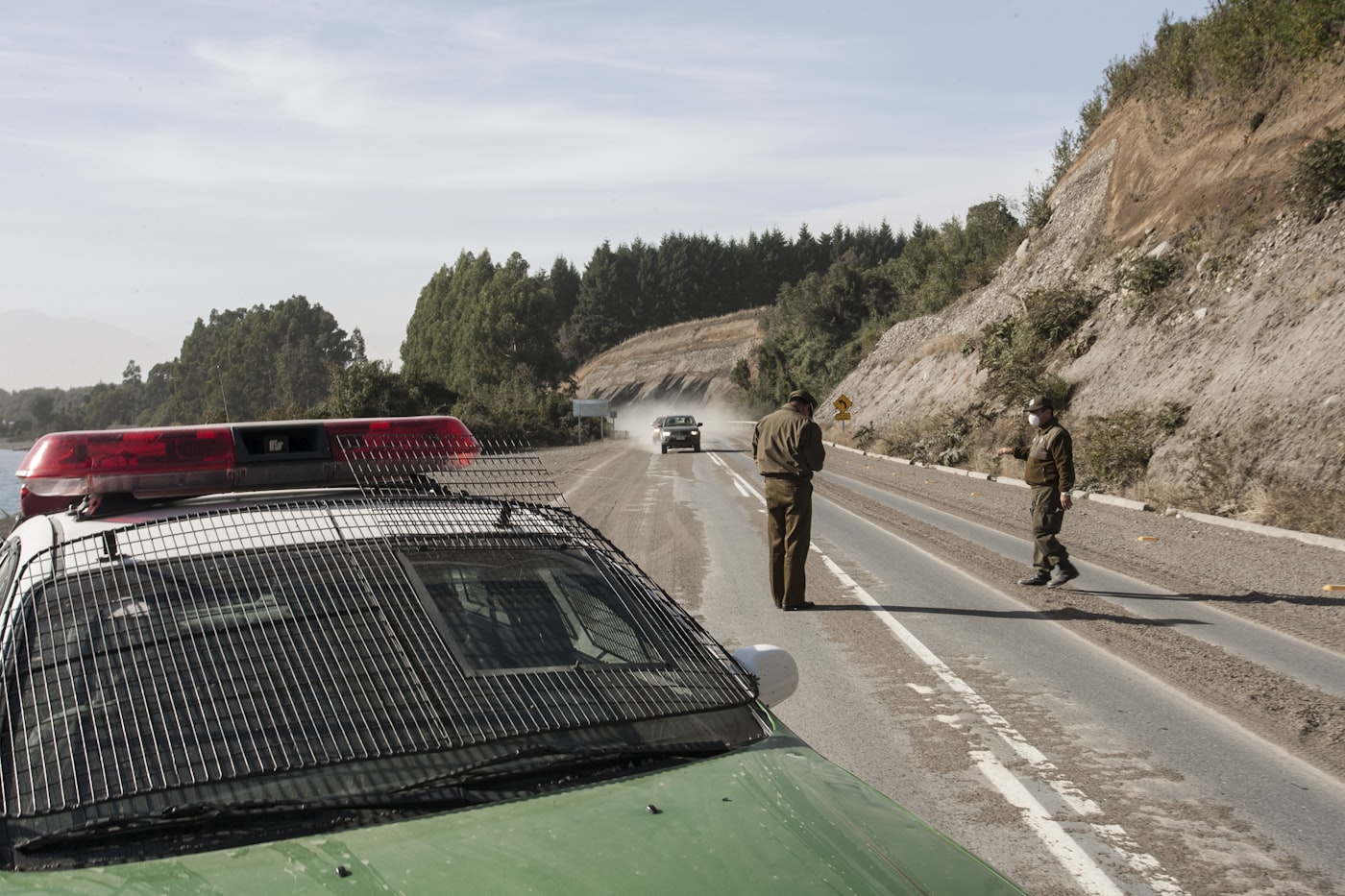 Police officer conducting a roadside breathalyzer test at a traffic stop