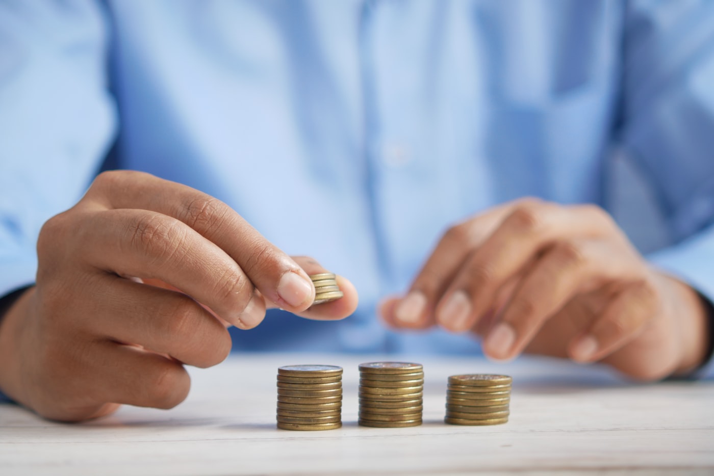 Person counting coins representing worries about the cost of treatment