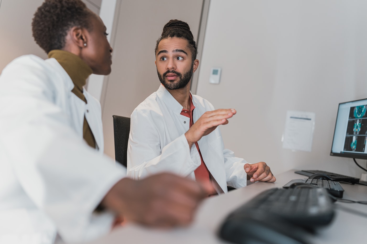 Doctor reviewing notes with a patient during an addiction assessment