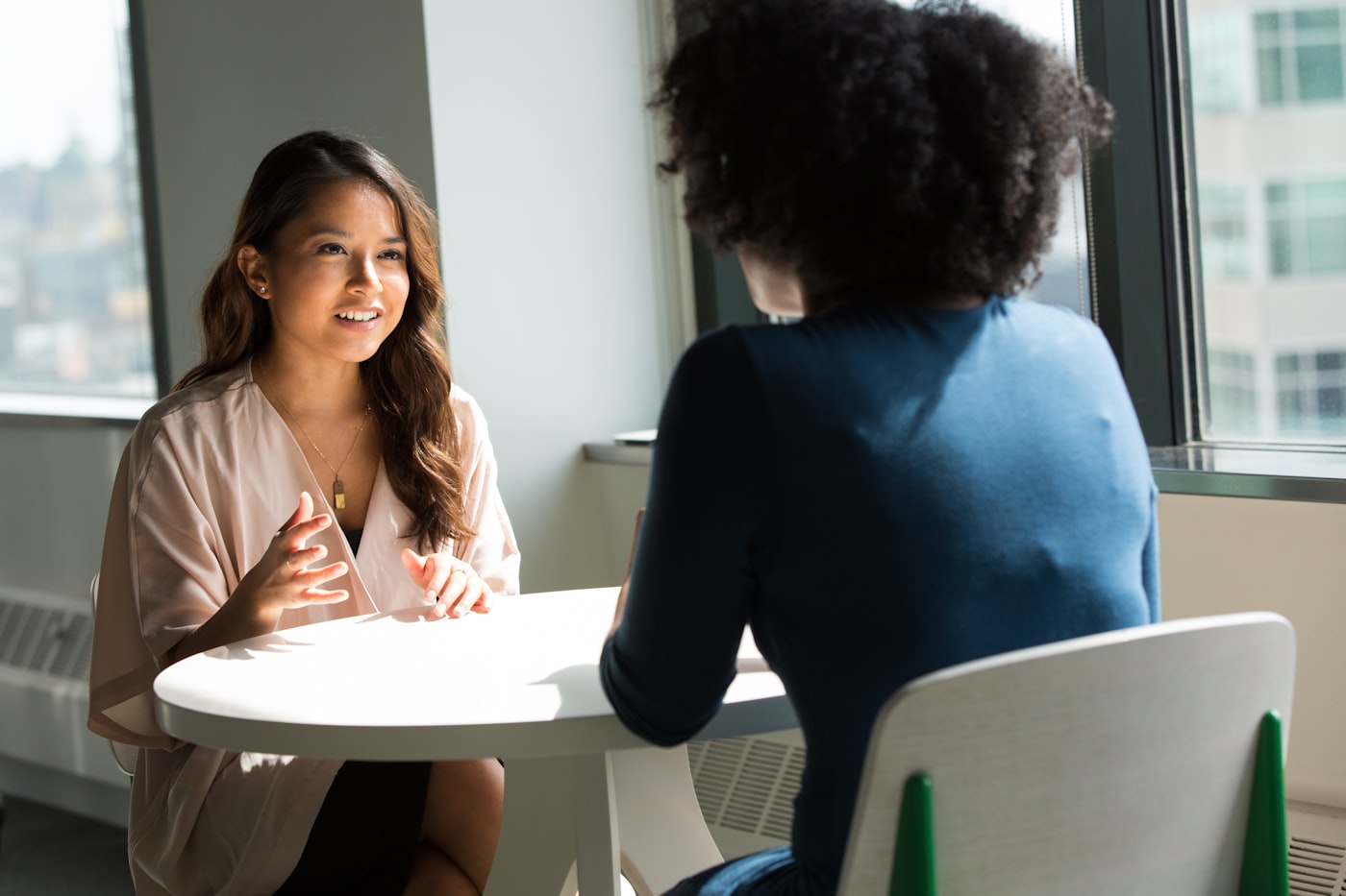 Two people in conversation reviewing options after primary treatment