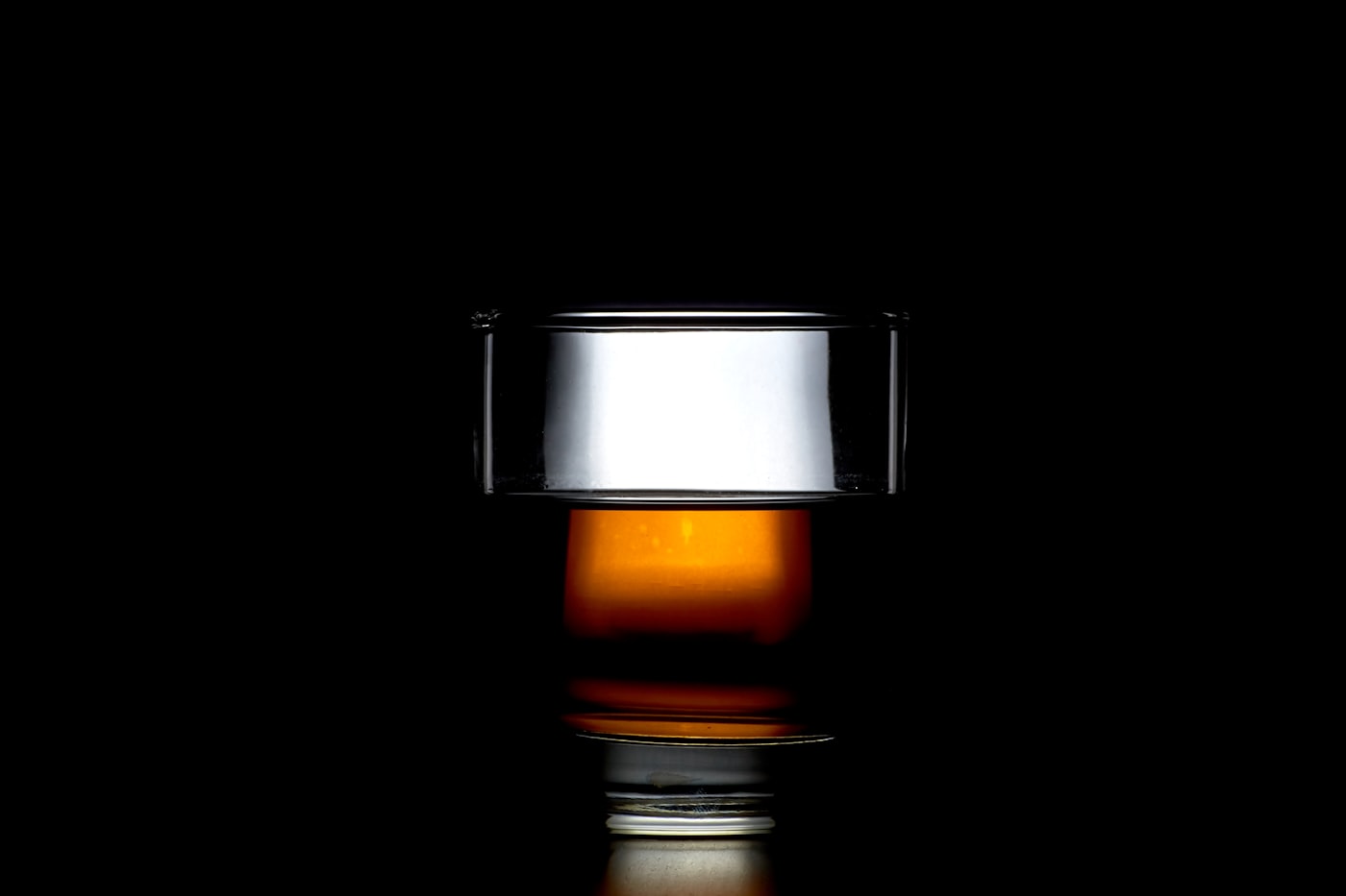 Single glass of whiskey on a table symbolizing warning signs of problem drinking