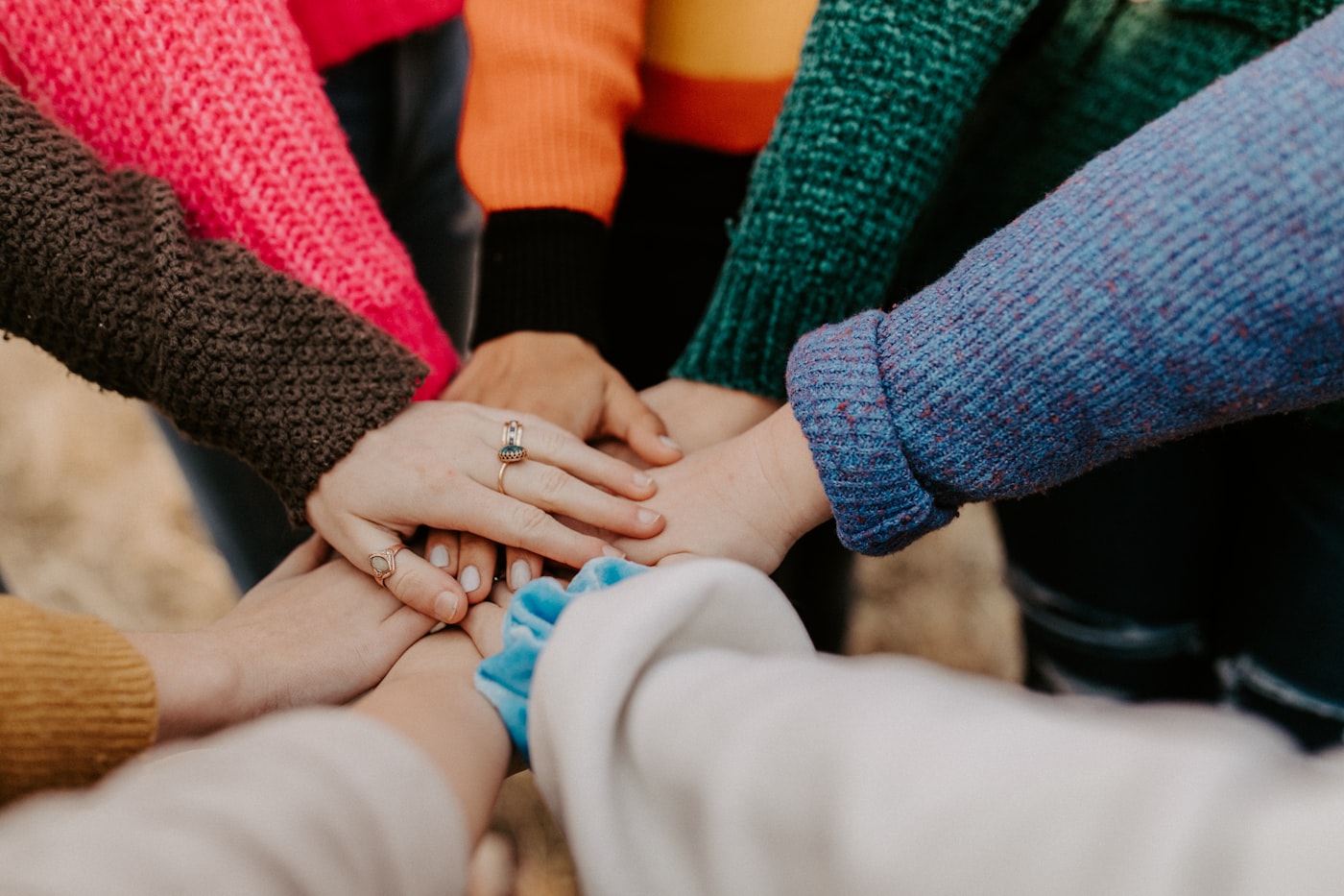 Group of adults sitting together in a warm, supportive peer meeting circle