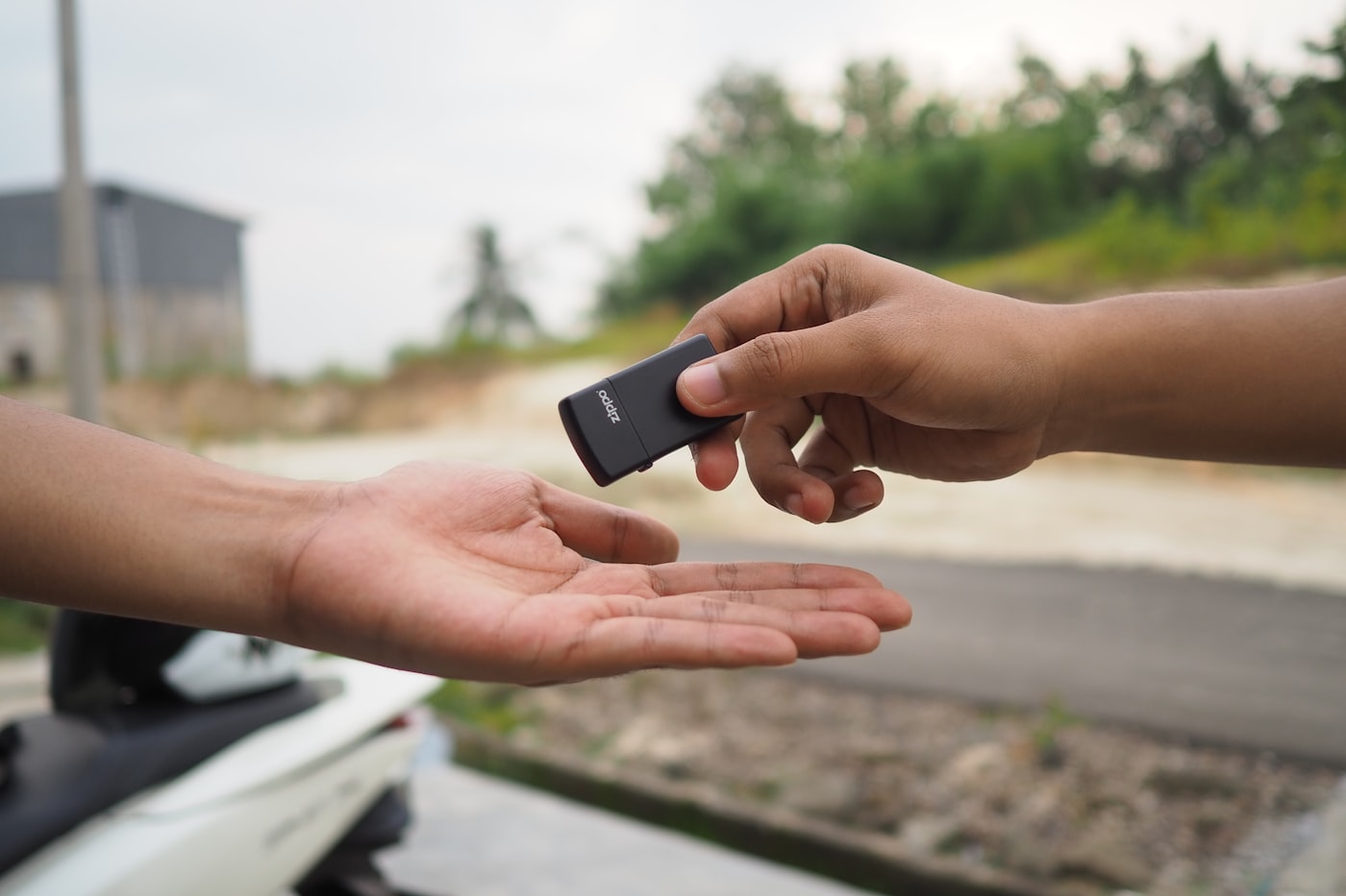 Person handing car keys to a friend to prevent impaired driving