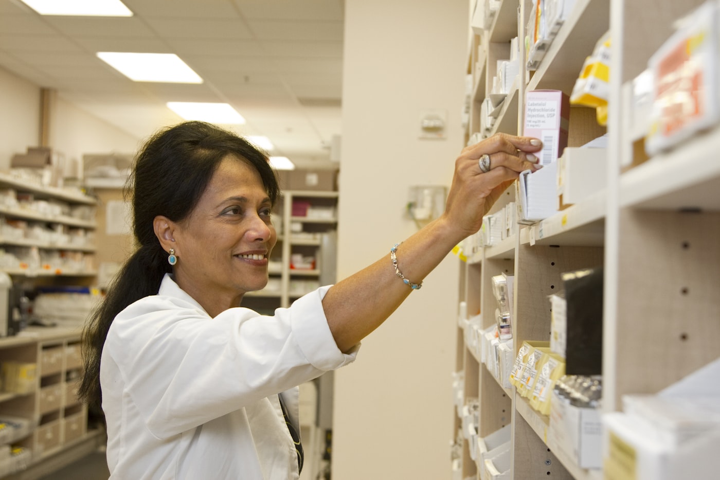 Pharmacist dispensing prescribed medication as part of opioid treatment