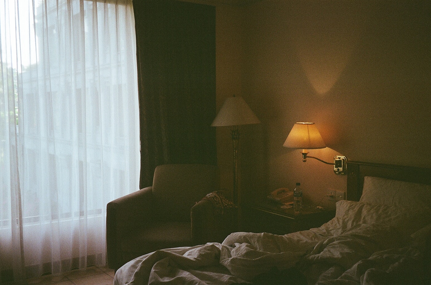 Withdrawn young person isolating alone in a dark room, a psychological sign of drug use