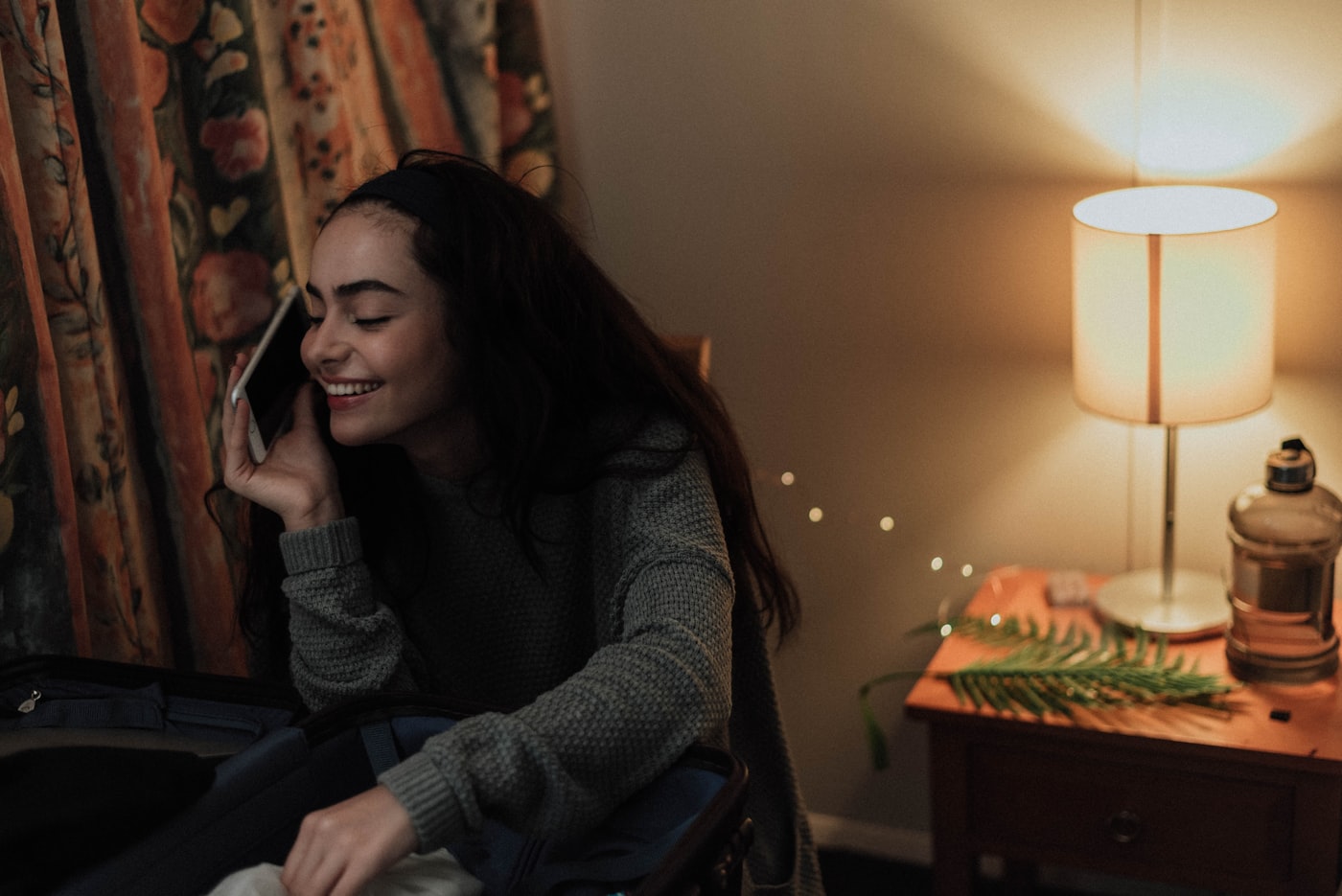 Person making a supportive phone call in a bright, calm room