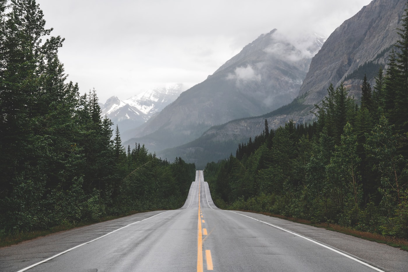 Open road stretching toward mountains at dawn representing a hopeful future