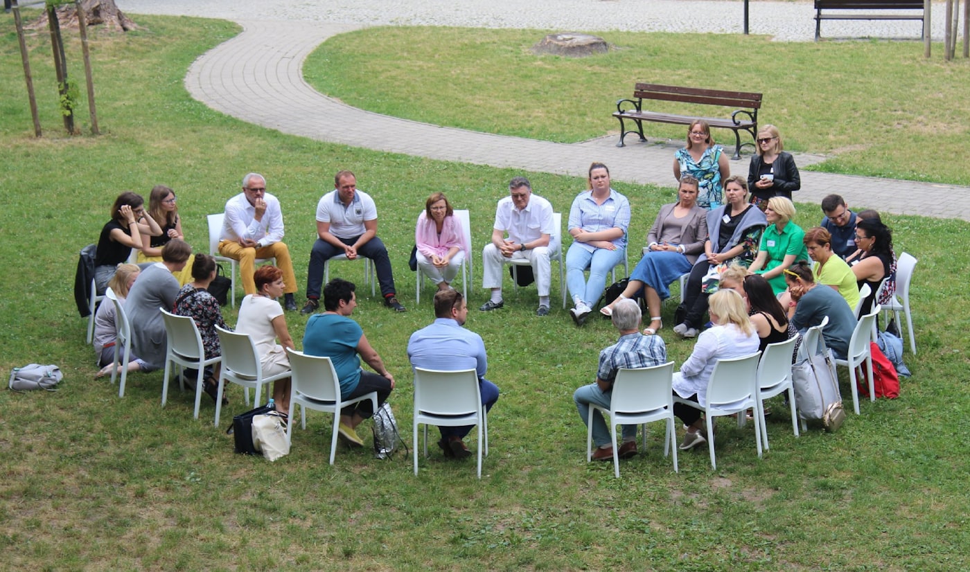 Supportive group therapy circle with people listening and encouraging one another