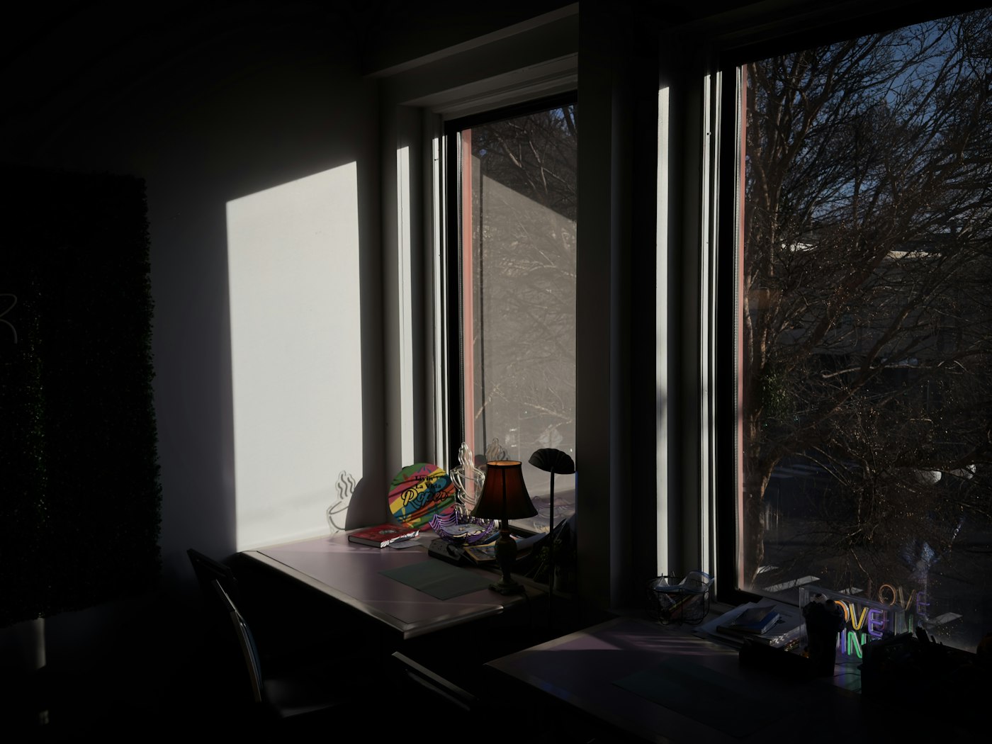 Person journaling peacefully by a bright window with a cup of tea