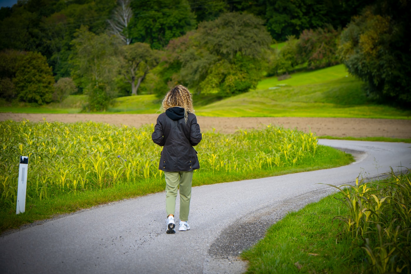 Woman walking along a quiet country path during addiction recovery
