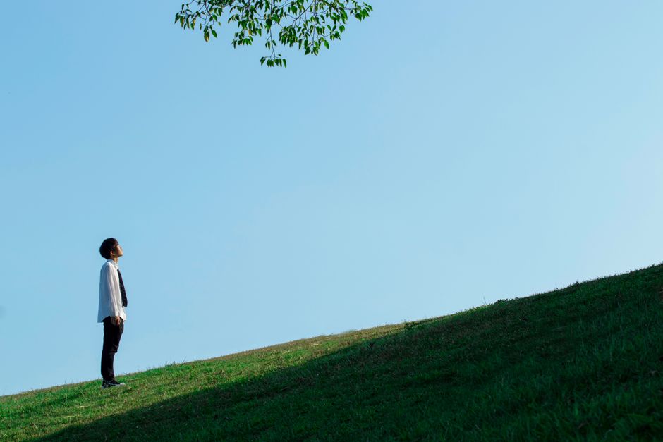 Young person looking out toward an open landscape representing long-term recovery