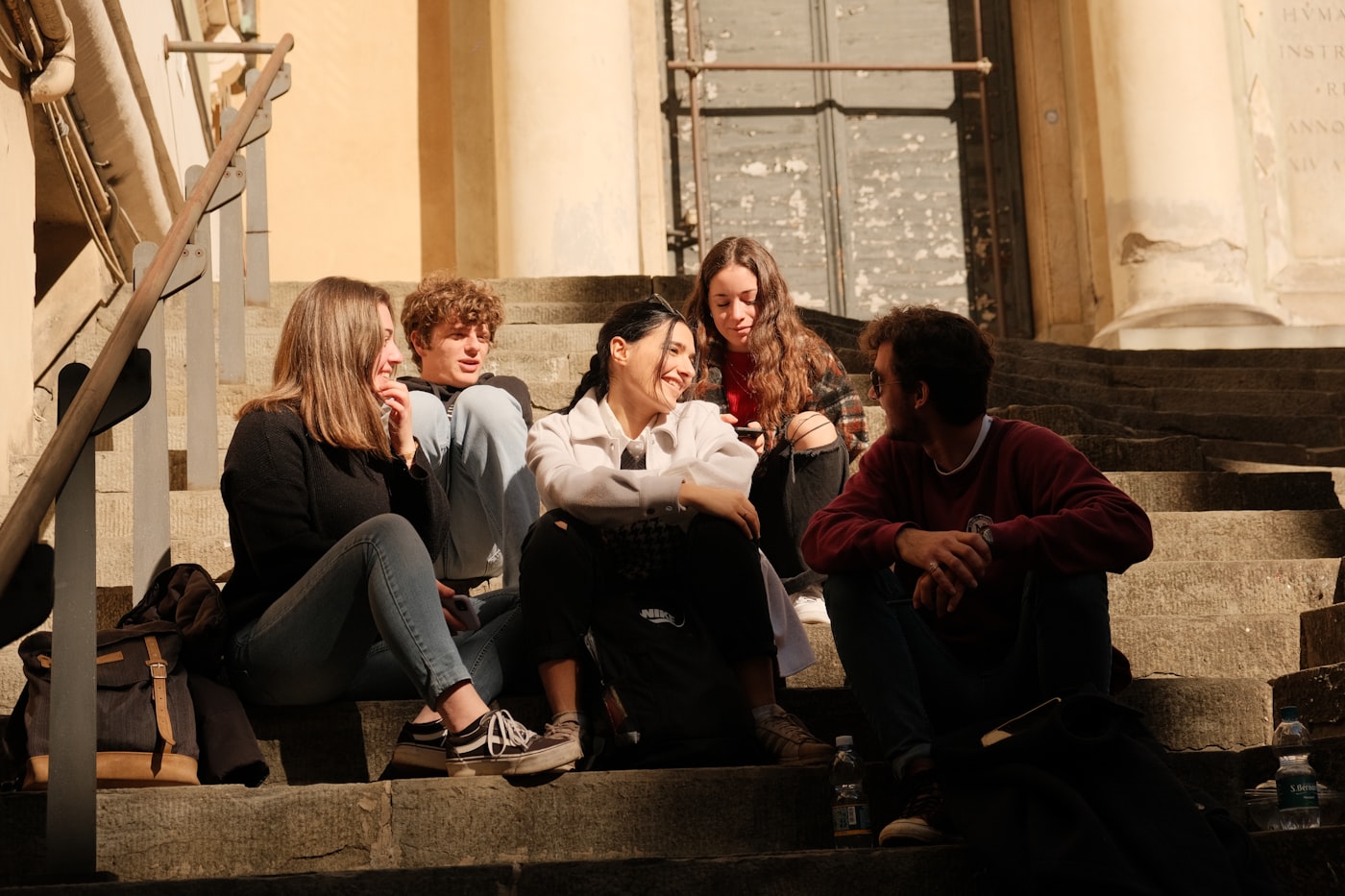 Young people sitting together in a peer support group circle